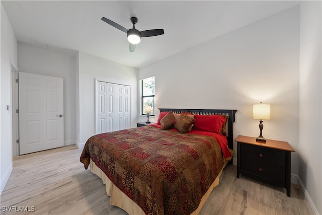 bedroom featuring ceiling fan, light hardwood / wood-style flooring, and a closet