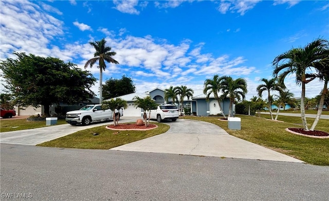 single story home with a garage and a front lawn