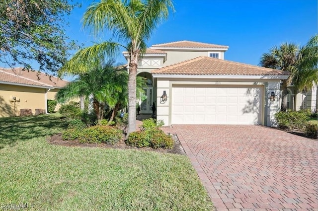 mediterranean / spanish-style house with a garage and a front lawn