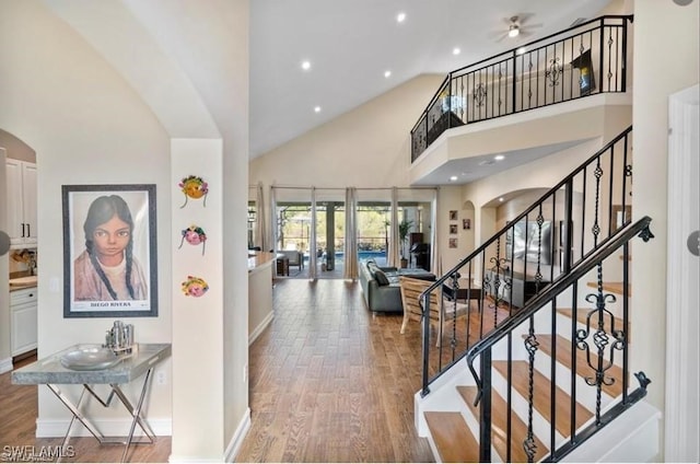 interior space featuring hardwood / wood-style flooring, ceiling fan, high vaulted ceiling, and french doors