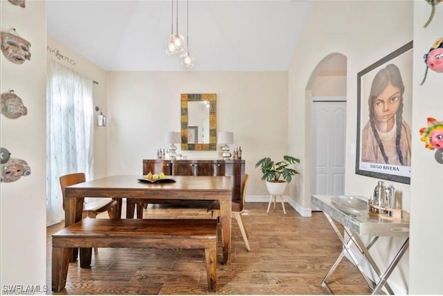 dining space with hardwood / wood-style flooring