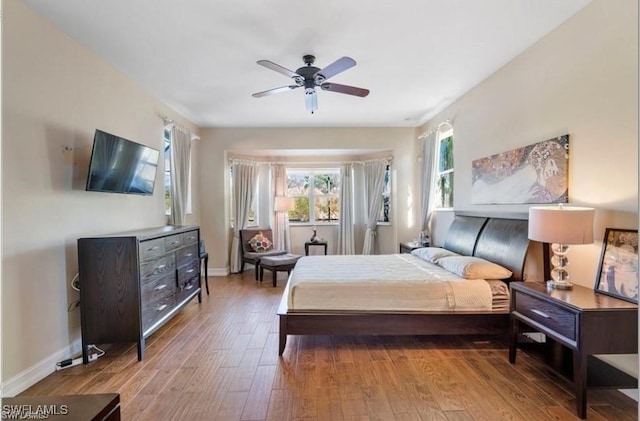 bedroom with hardwood / wood-style floors and ceiling fan