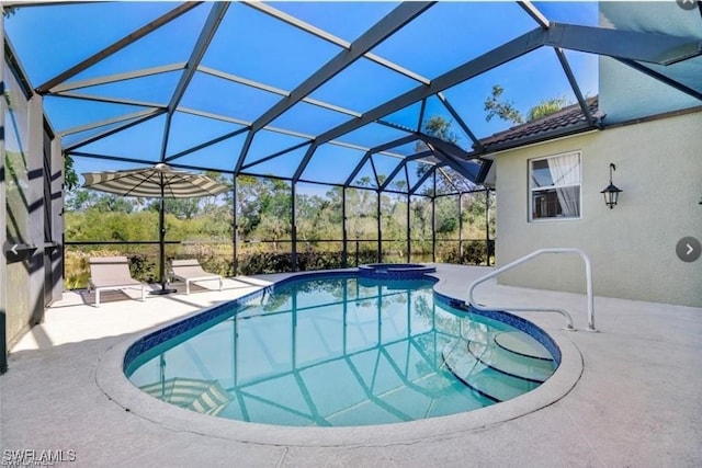 view of swimming pool featuring an in ground hot tub, a lanai, and a patio area