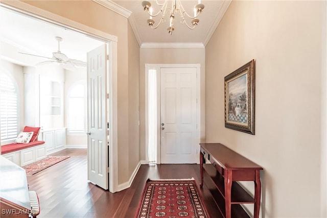 entrance foyer featuring dark hardwood / wood-style flooring, ceiling fan with notable chandelier, and ornamental molding