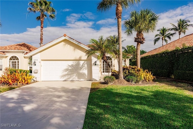 view of front of house featuring a front yard and a garage