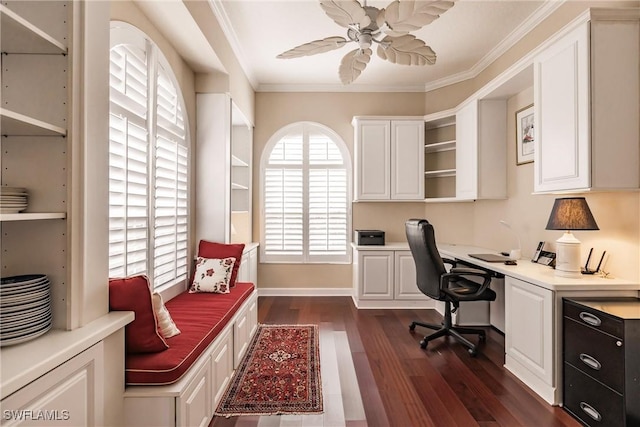 office with ceiling fan, dark wood-type flooring, built in desk, and ornamental molding