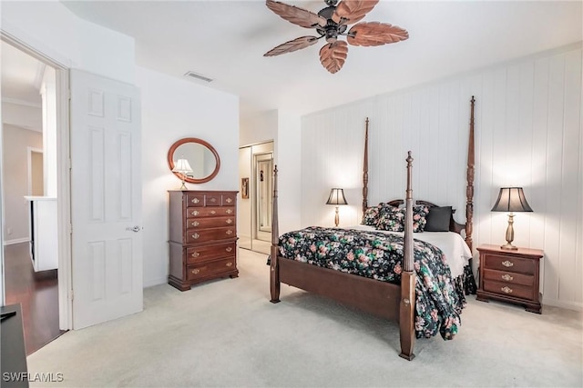 carpeted bedroom featuring ceiling fan and a closet