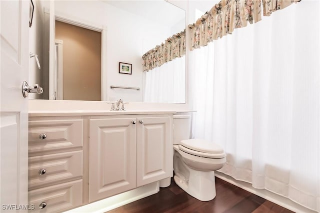 bathroom featuring hardwood / wood-style flooring, vanity, and toilet