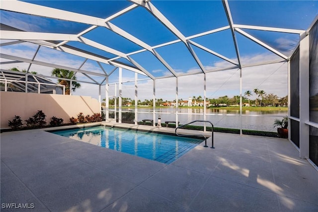 view of swimming pool with a patio, a water view, and glass enclosure