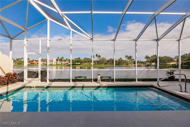 view of pool with a water view, glass enclosure, and a patio area