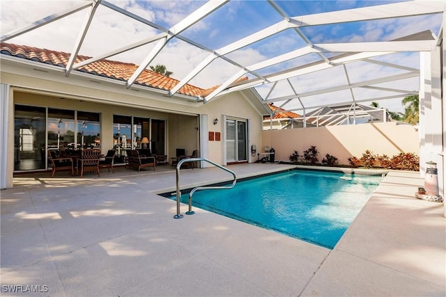 view of swimming pool with an outdoor living space, a patio, and glass enclosure