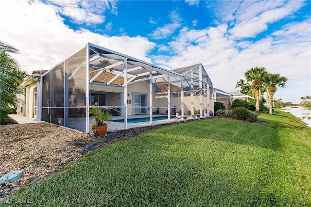 view of home's exterior featuring glass enclosure and a yard