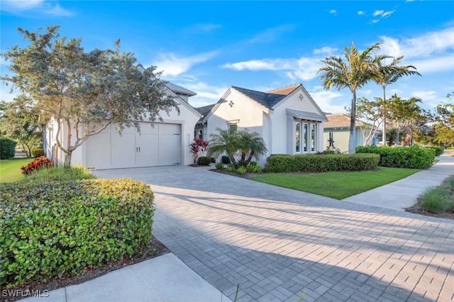 view of front of property with a front yard and a garage