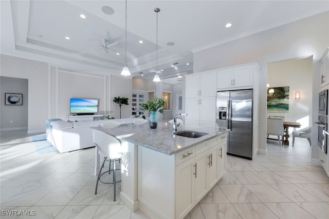 kitchen featuring white cabinets, sink, a kitchen island with sink, and appliances with stainless steel finishes