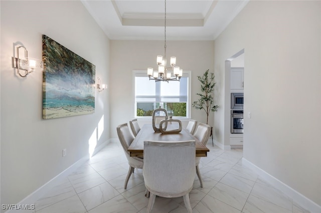 dining space with a chandelier, a raised ceiling, and ornamental molding