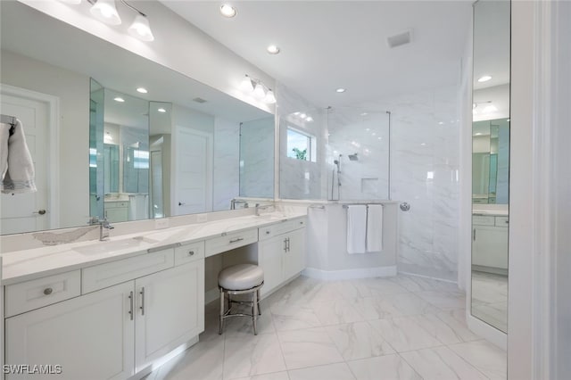 bathroom featuring vanity and tiled shower