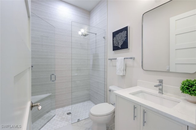 bathroom featuring tile patterned flooring, vanity, toilet, and walk in shower