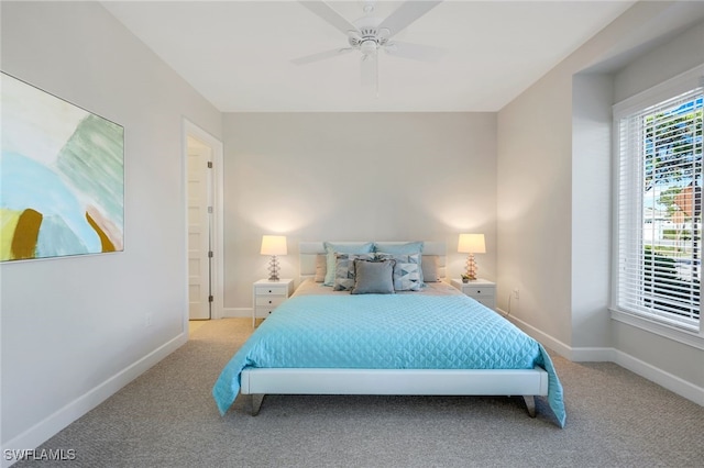 bedroom with ceiling fan and light carpet