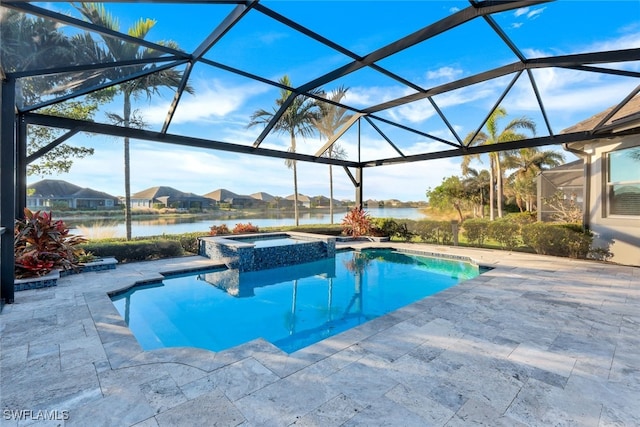 view of swimming pool with an in ground hot tub, a patio, a water view, and glass enclosure