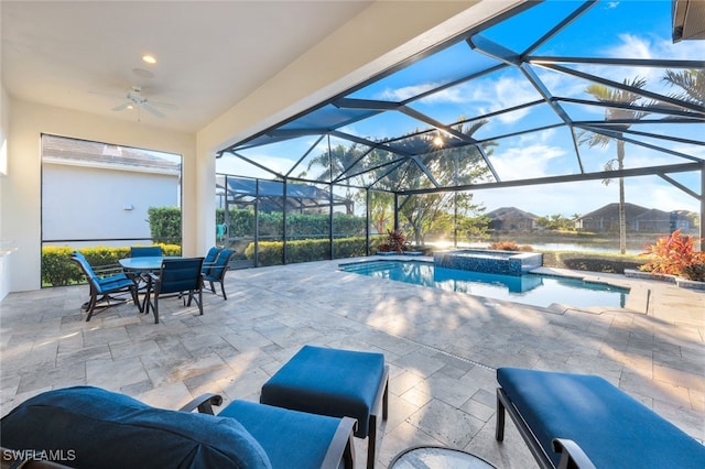 view of pool with glass enclosure, an in ground hot tub, ceiling fan, and a patio