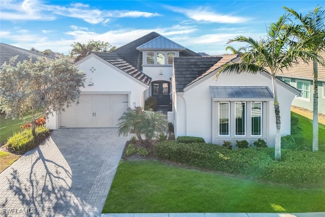 view of front of house featuring a front yard and a garage