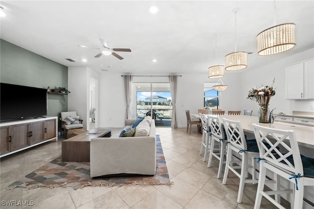 tiled living room with ceiling fan