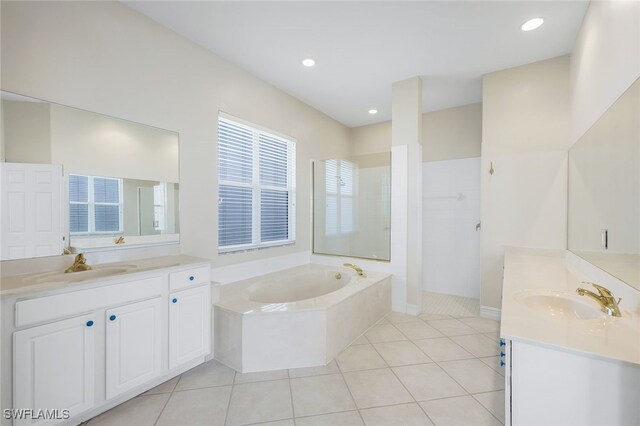 bathroom featuring tile patterned flooring, vanity, and separate shower and tub