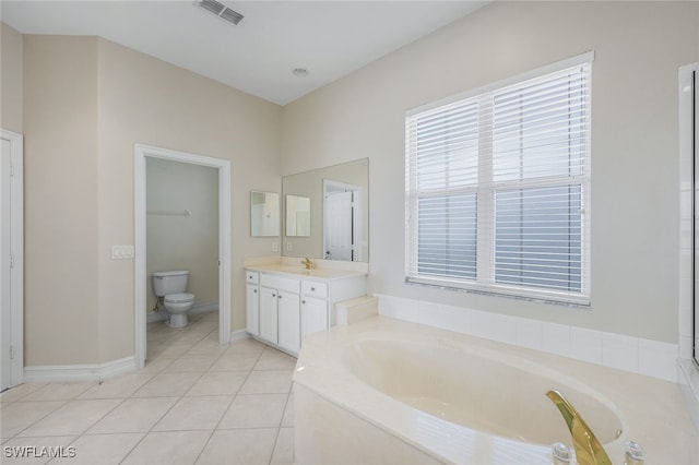 bathroom with a tub to relax in, tile patterned flooring, vanity, and toilet