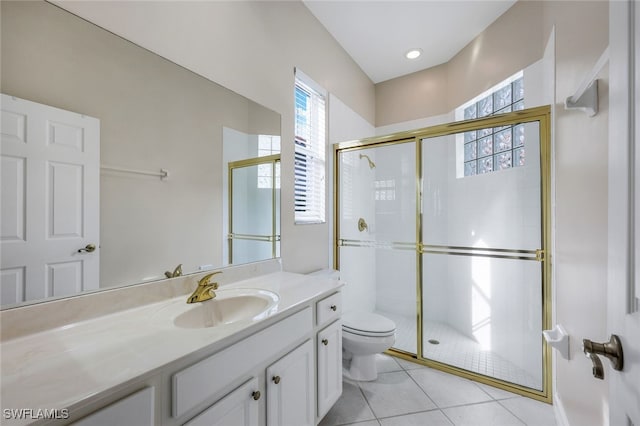 bathroom featuring tile patterned flooring, vanity, toilet, and a shower with door