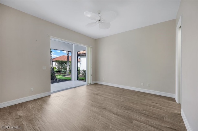 spare room with hardwood / wood-style flooring and ceiling fan