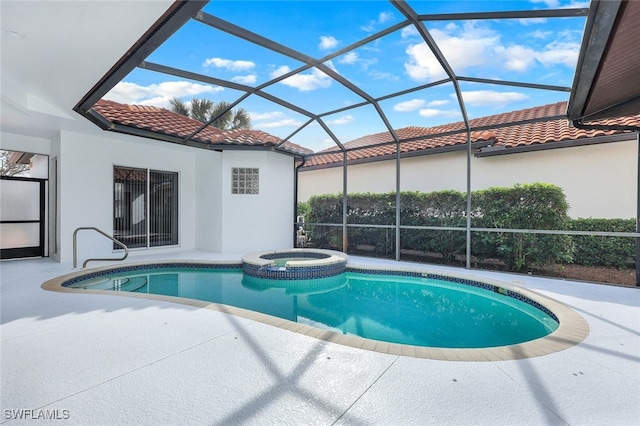 view of swimming pool with an in ground hot tub, a patio area, and a lanai