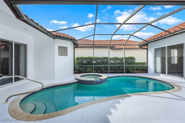 view of swimming pool featuring a lanai and an in ground hot tub