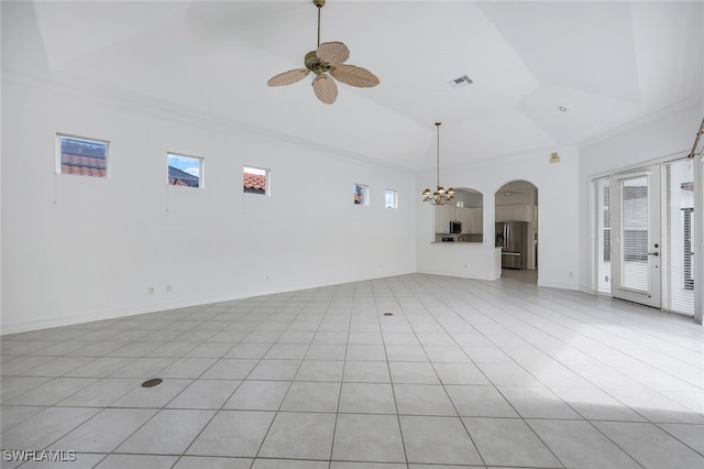 unfurnished living room with plenty of natural light, light tile patterned floors, ceiling fan with notable chandelier, and high vaulted ceiling