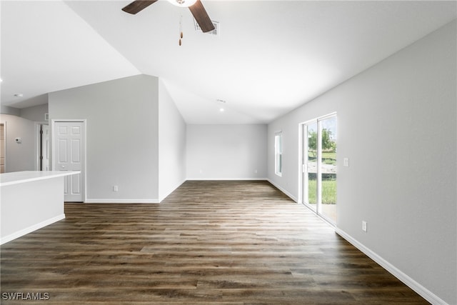 unfurnished living room with ceiling fan, dark hardwood / wood-style flooring, and vaulted ceiling