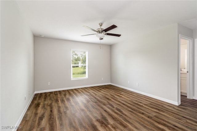 empty room with dark hardwood / wood-style flooring and ceiling fan