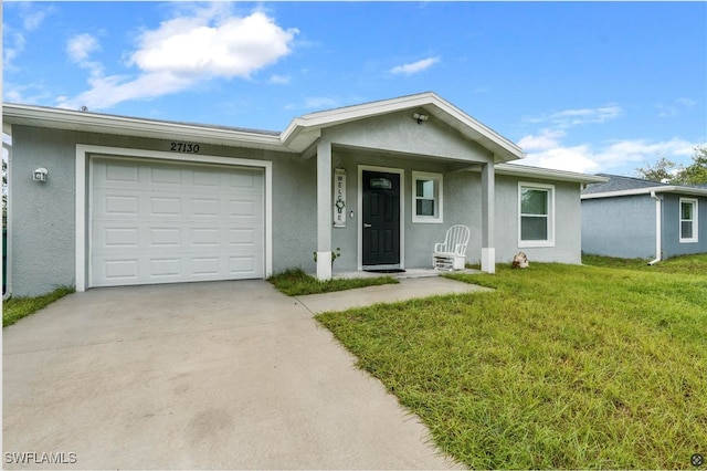 ranch-style house featuring a garage and a front lawn