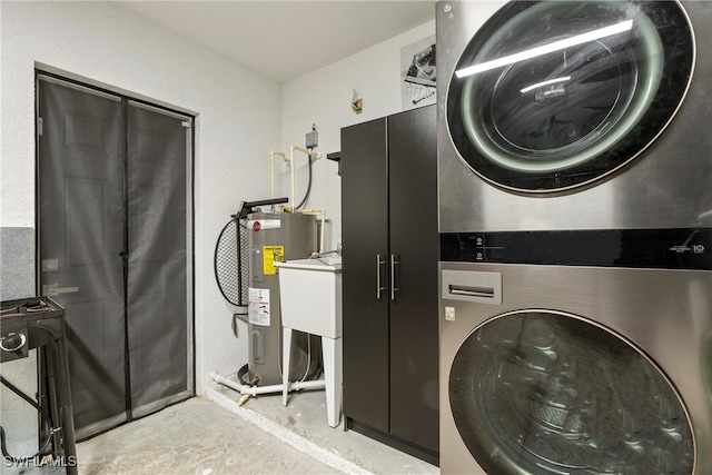 laundry room with electric water heater and stacked washer / drying machine