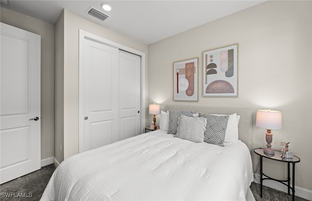 bedroom featuring a closet and dark carpet