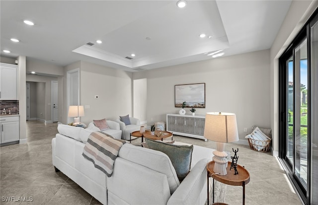 living room featuring a tray ceiling