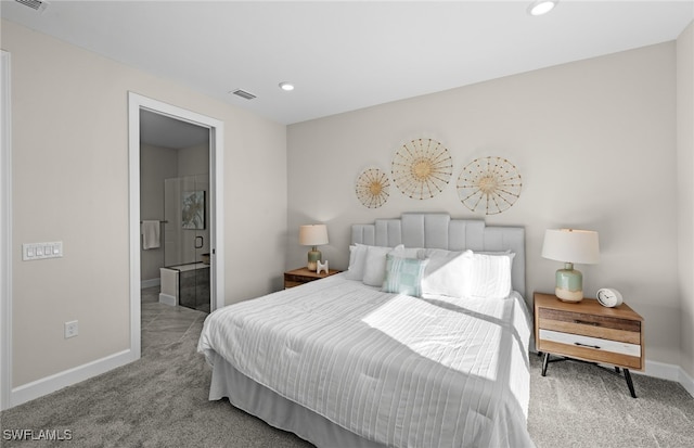 carpeted bedroom featuring ensuite bath