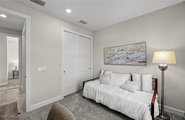 bedroom with light colored carpet and a closet