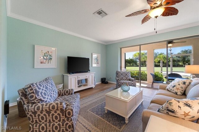 living room with hardwood / wood-style floors and ornamental molding