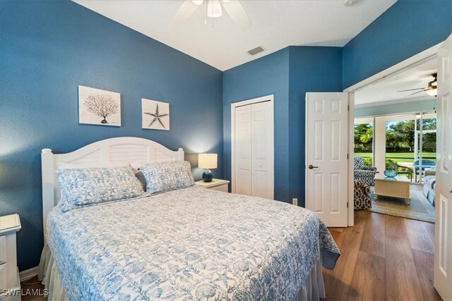 bedroom with a closet, dark hardwood / wood-style floors, and ceiling fan