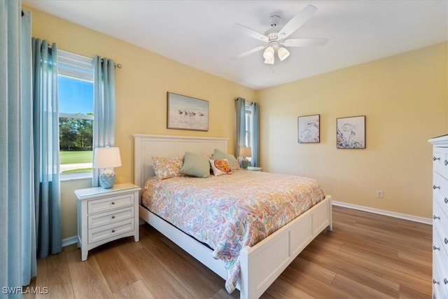 bedroom with ceiling fan and light hardwood / wood-style flooring