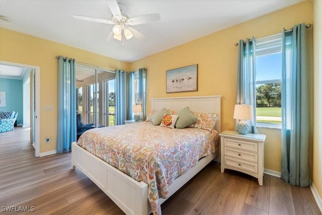 bedroom with access to exterior, ceiling fan, baseboards, and wood finished floors