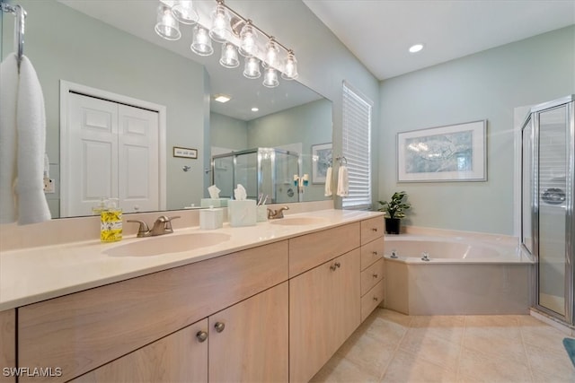 bathroom with tile patterned flooring, vanity, and independent shower and bath