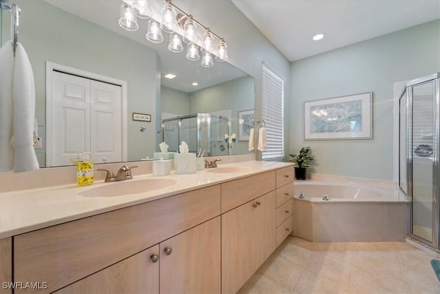 full bath featuring double vanity, tile patterned flooring, a sink, and a shower stall