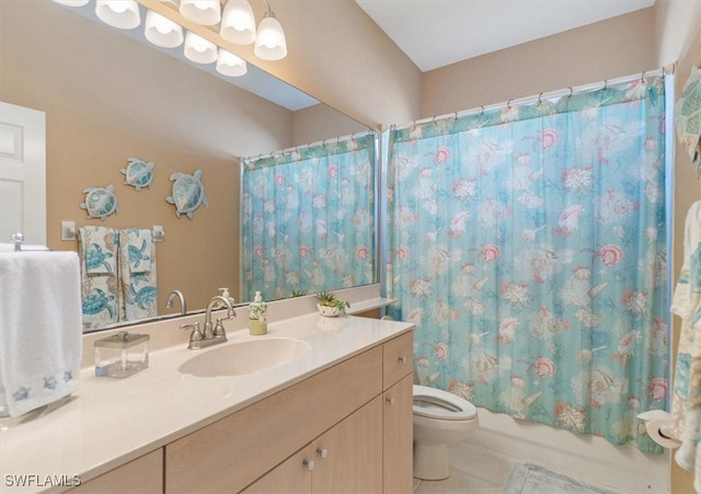 full bathroom with tile patterned flooring, shower / bath combination with curtain, vanity, and toilet