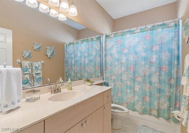 bathroom featuring tile patterned flooring, shower / tub combo with curtain, vanity, and toilet