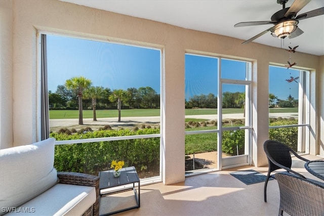 sunroom / solarium featuring a wealth of natural light and ceiling fan